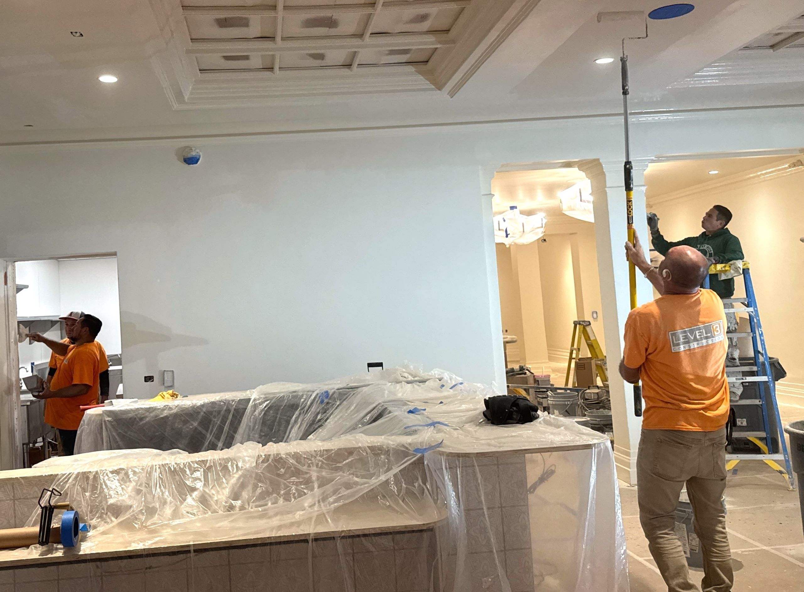 Hotel Renovation Carried Out By the Level 3 Construction Team Construction workers from Level 3 Construction renovating a hotel lobby