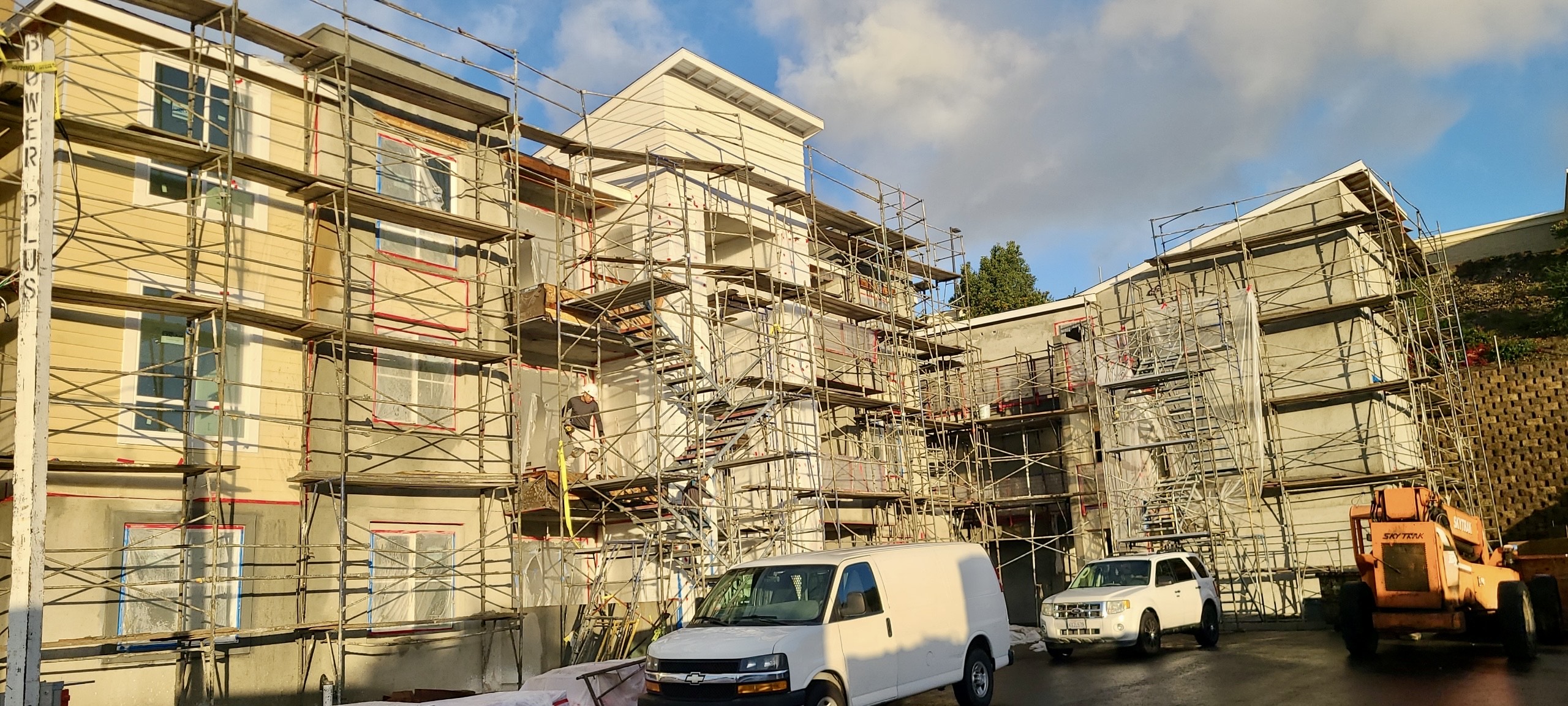 La Costa Family Apartments under construction in Carlsbad, California. The image shows the east side of this multi-story building surrounded by scaffolding.