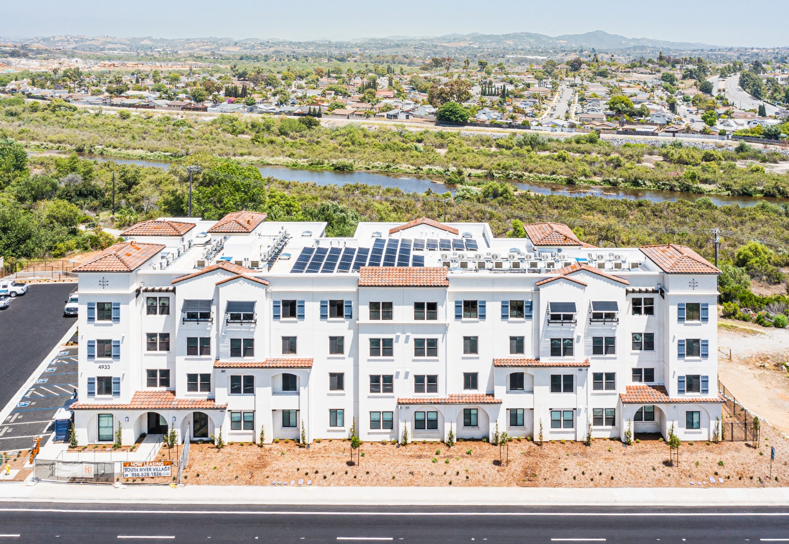 South River Village at Completion - edited by Westpine Co and cropped Built by Level 3 Construction, South River Village is a four-story Spanish Mission style affordable housing development in Oceanside, California. The community features 43 apartments: 20 one bedrooms, 12 two bedrooms, and 11 three bedrooms. Fifteen percent of the apartments are ADA-accessible. It also includes a children's play area and two barbeque stations.
