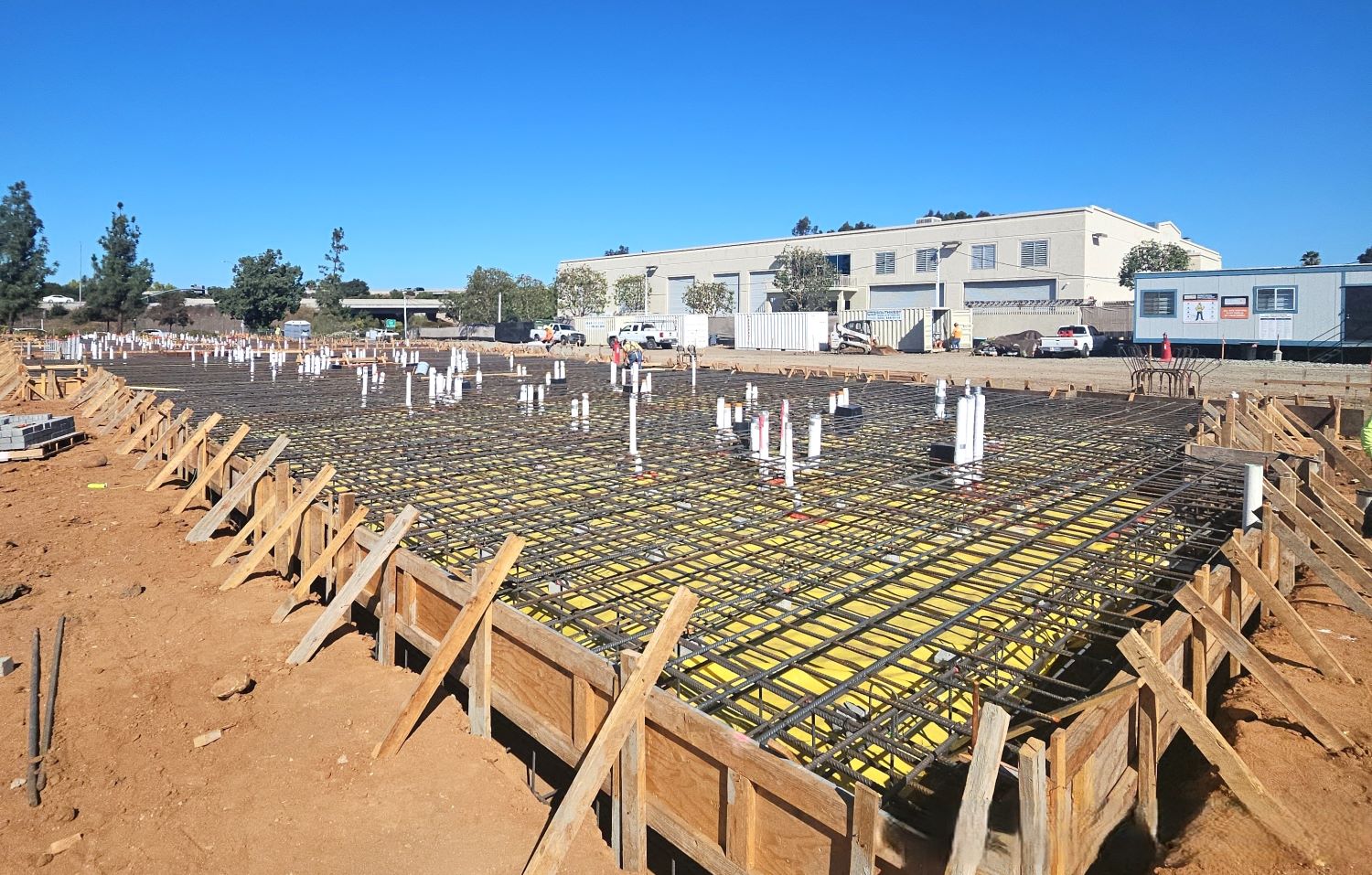 Reinforced concrete foundation with rebar grid and post-tension cables under construction at WoodSpring Suites Santee in Santee, California, by Level 3 Construction